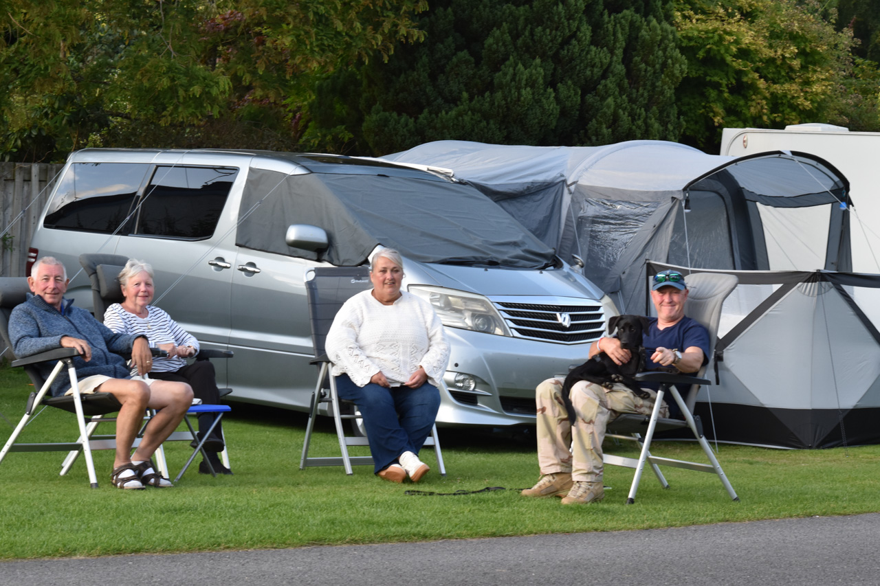 Four People Outside their Tent